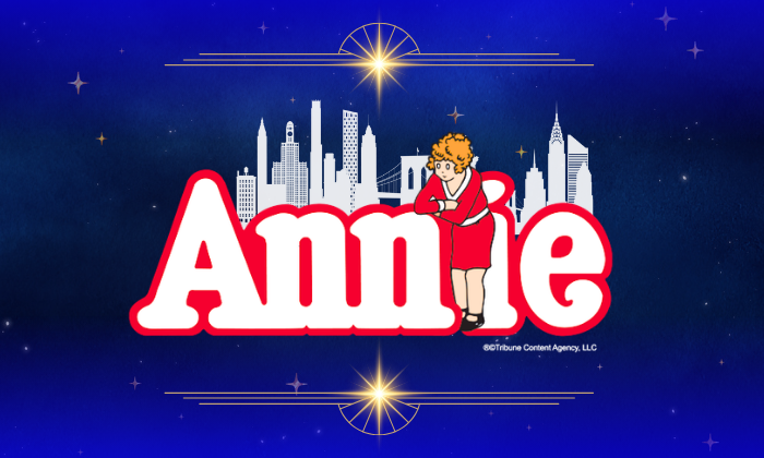 Annie logo featuring the red-haired title character against a white city skyline and starry blue background.